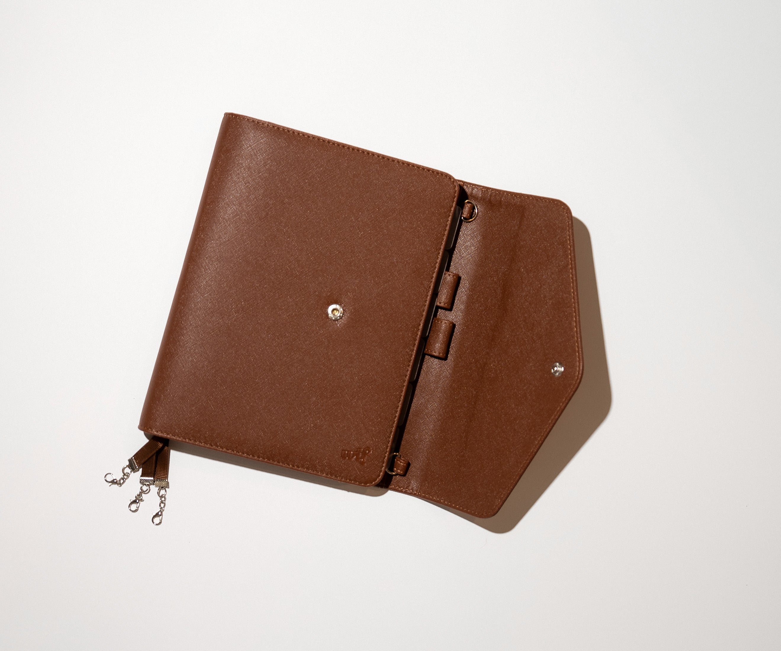 The WTF Journal in Dark Choc Brown, opened flat to show the interior, silver ribbon clasps and debossed wtf logo